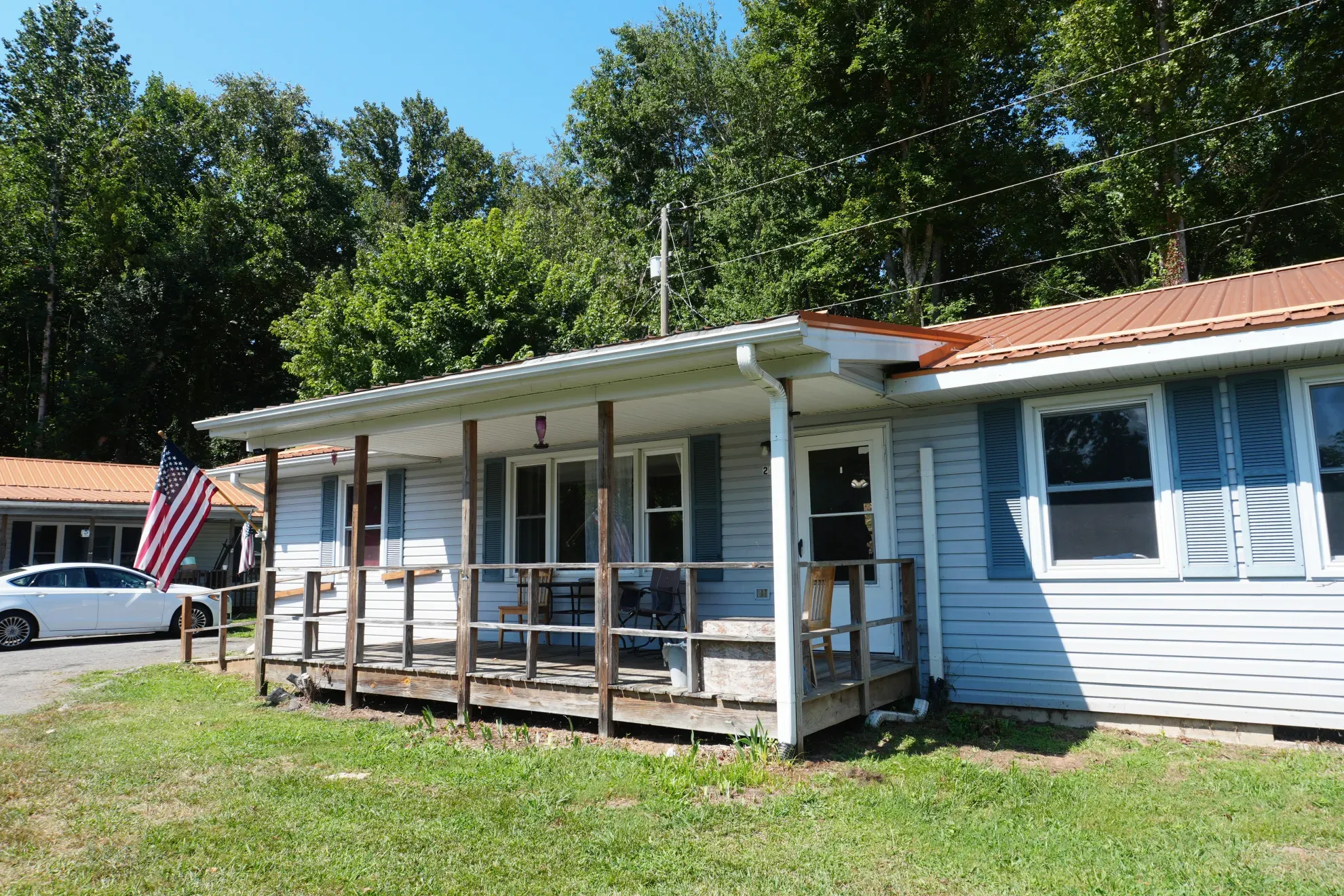 The front of one of the homes seen from the drive, with the porch running its full length.