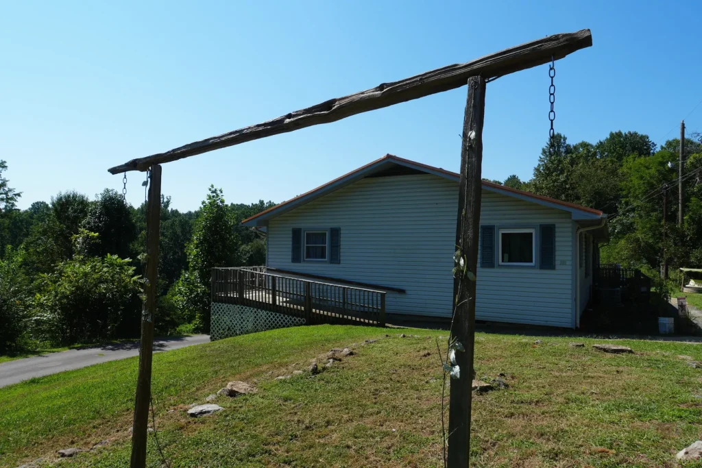 A single-storey home with a ramp to the front door, seen across the lawn.